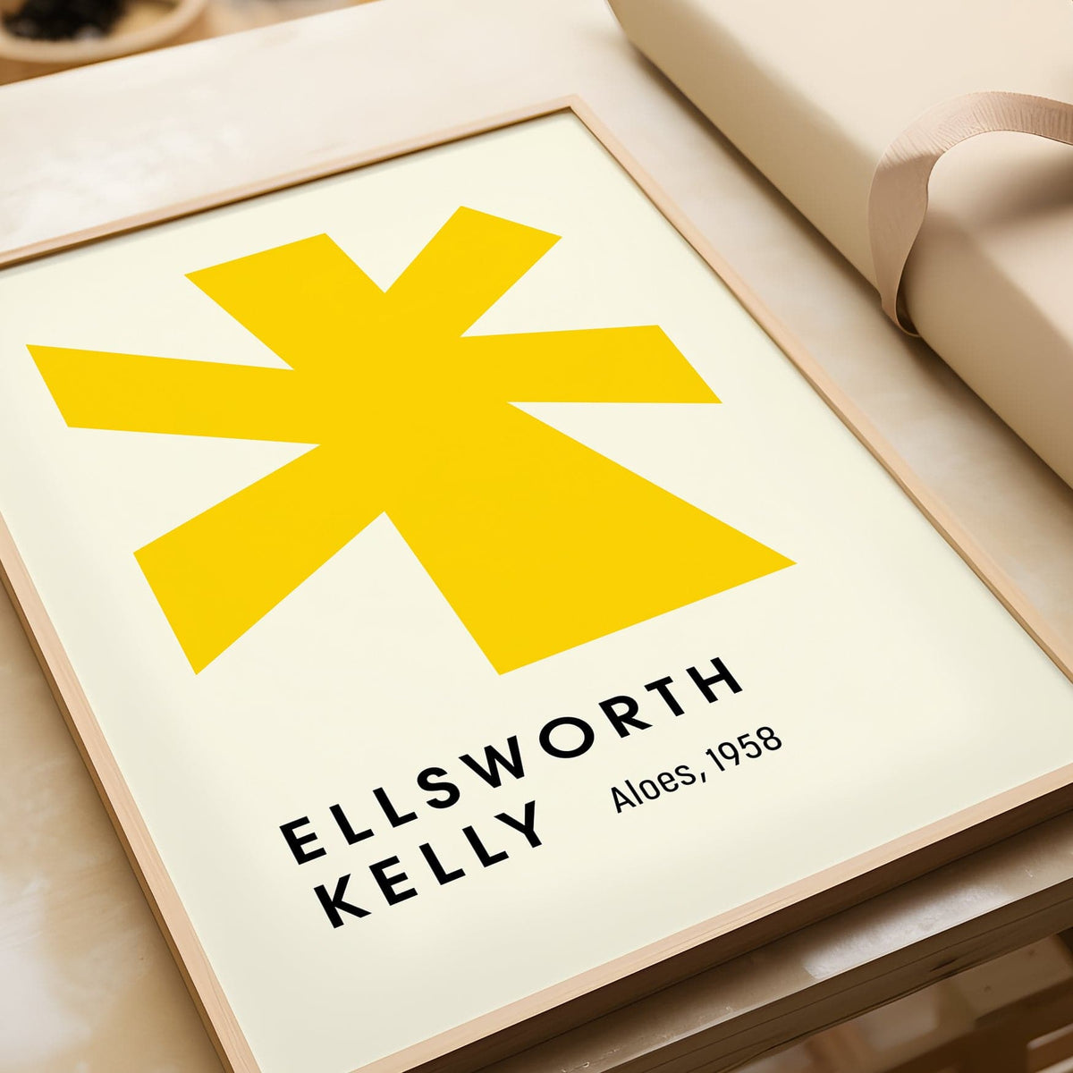 Close-up of large minimalist wall art with a yellow abstract shape on a cream background