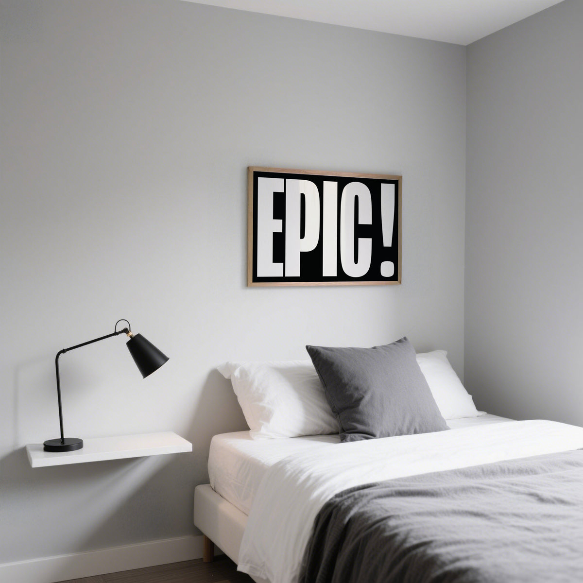 Posters Bold Font wall art with white text on black background above a bed with grey and white bedding
