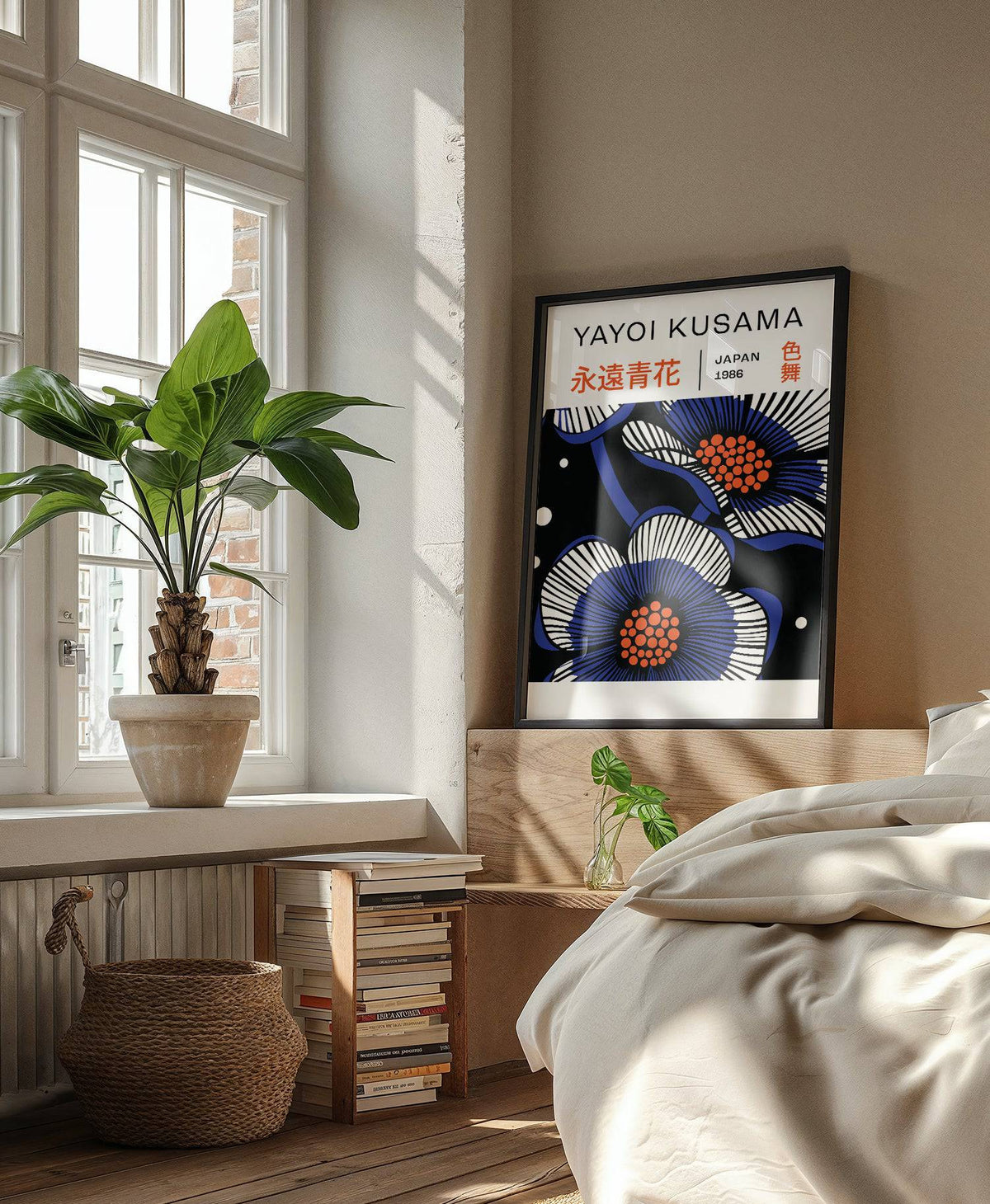 Blue Flower Poster print leaning on a wooden bedside table with a green plant and sunlight