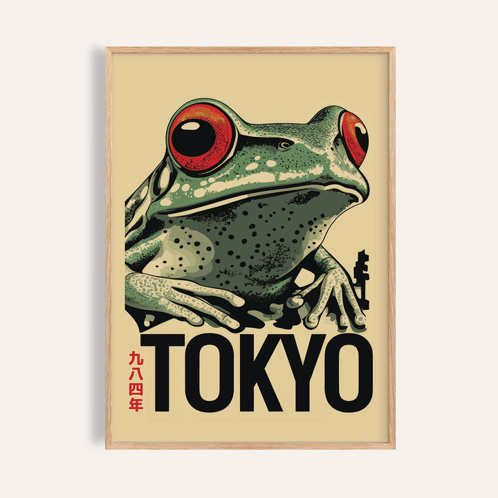 Close-up of frog poster with red eyes and Tokyo text in a wooden frame