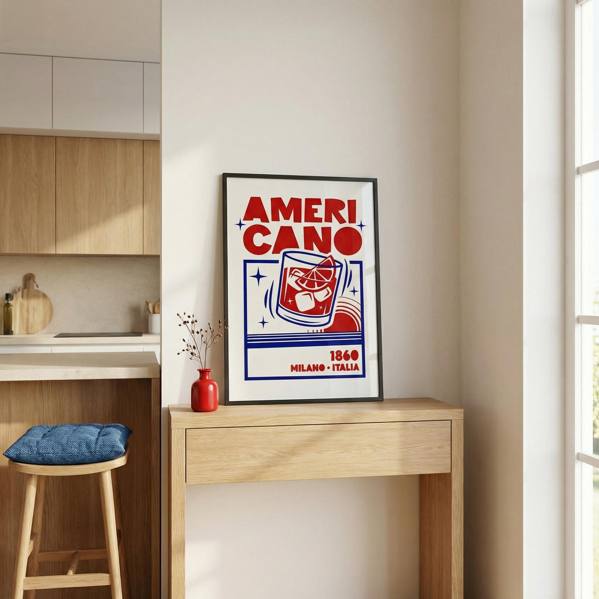Americano Cocktail Poster print leaning on a wooden console with a red vase in a kitchen corner