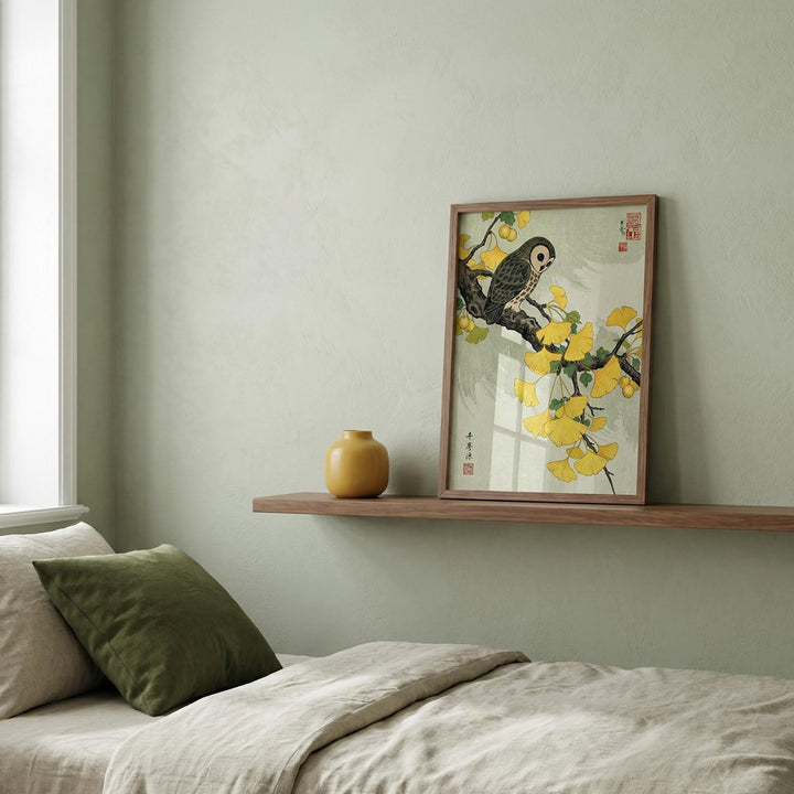 Owl and Ginkgo Print leaning on a wooden shelf with a yellow vase in a bedroom