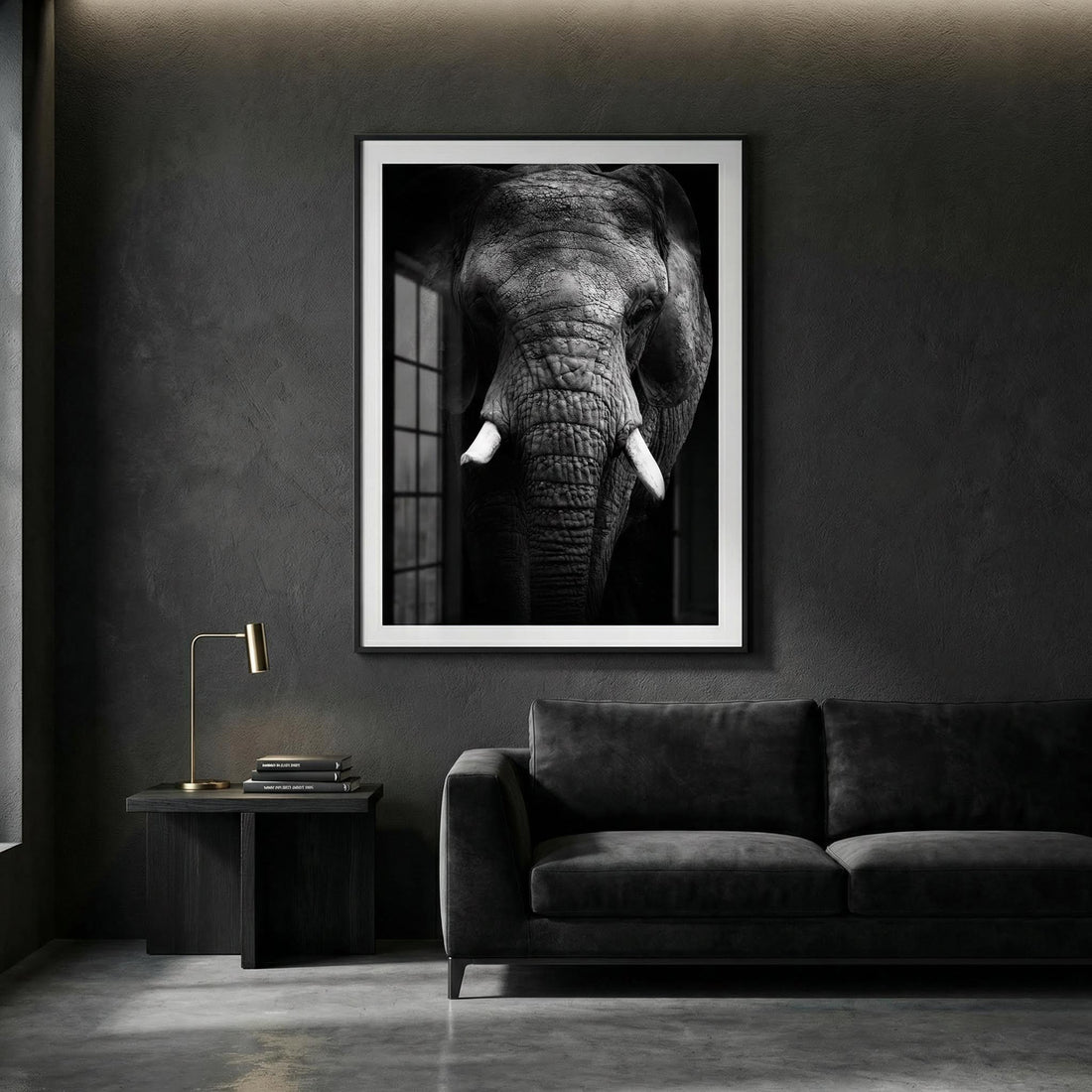 Dark living room with charcoal walls, a black sofa and a brass lamp beneath a large black and white elephant print with a white border