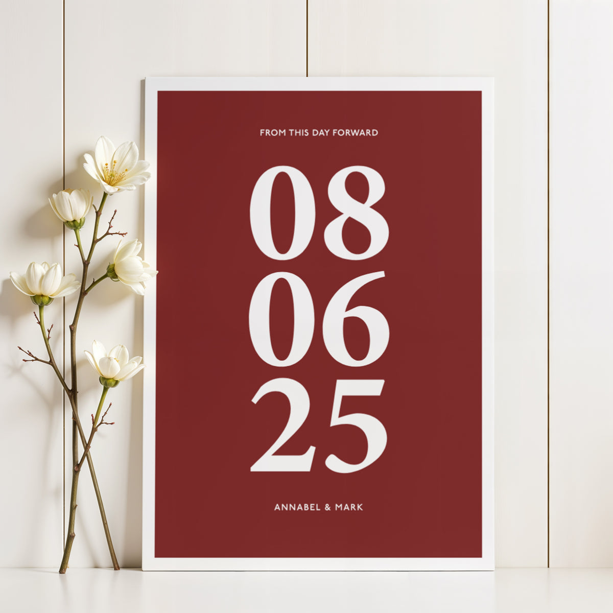 Print leaning on a shelf personalized anniversary gift with white bold numbers on dark red background and white flowers