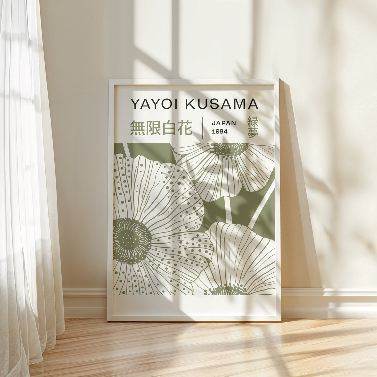 Sage Green Wall Art print leaning on a wooden floor with natural light and sheer curtains