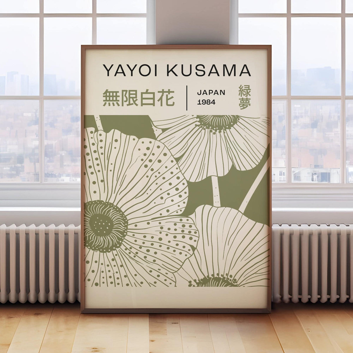Sage green wall art with large poppy flowers in a minimalist style leaning on a radiator by a window