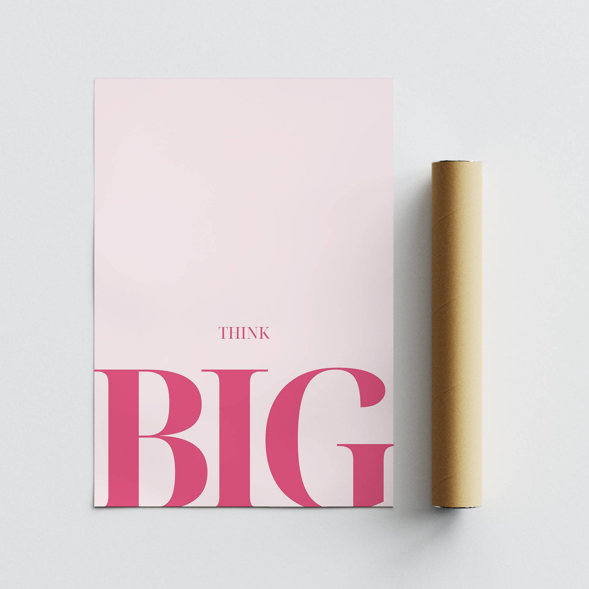 Think Big typography print in pink and white beside a brown packaging tube