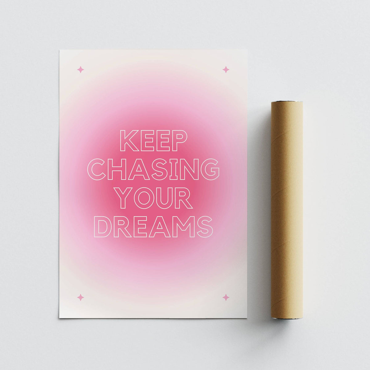Minimalist typographic motivational wall art in pink and white with a packaging tube