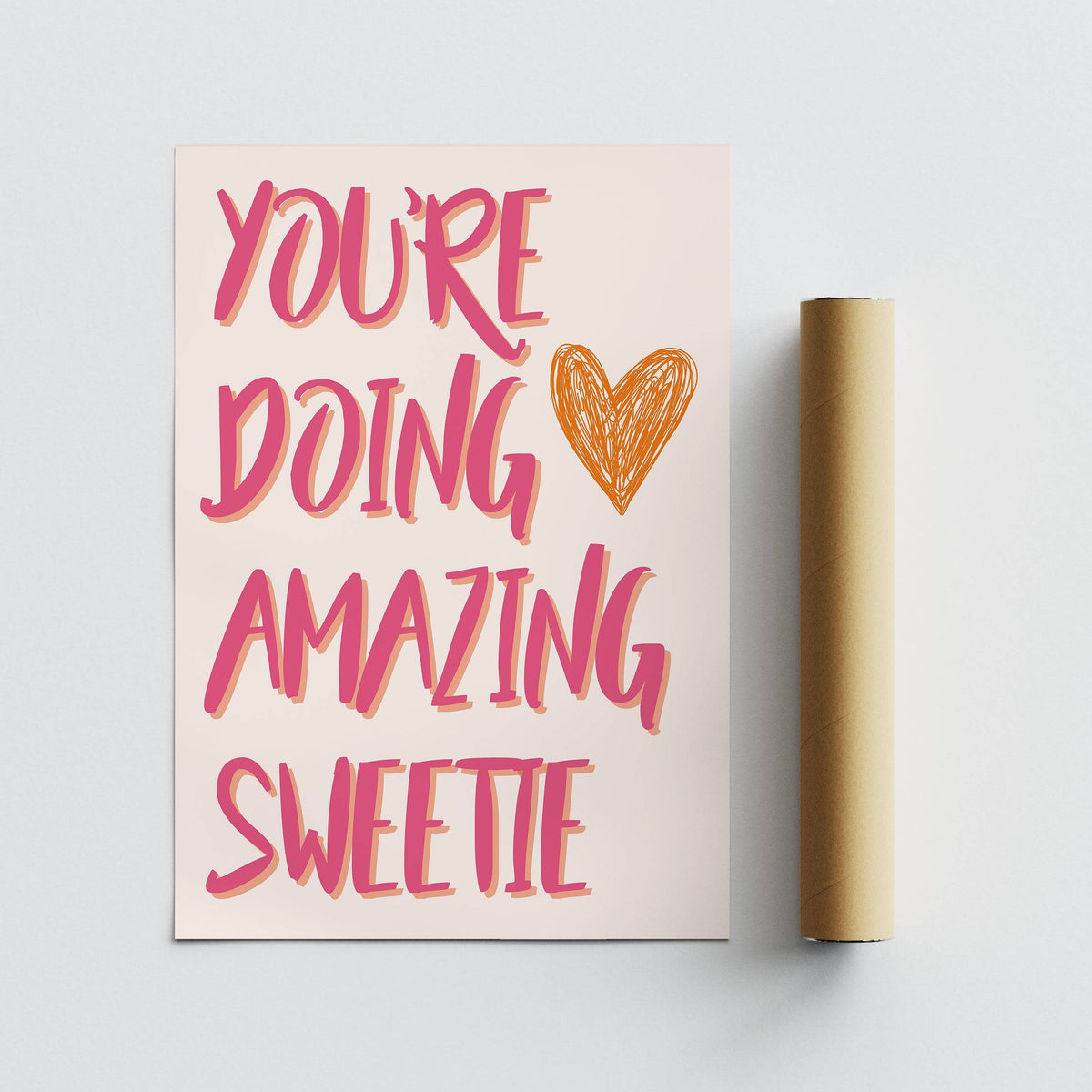 Good Motivational Posters print with orange heart next to a brown packaging tube