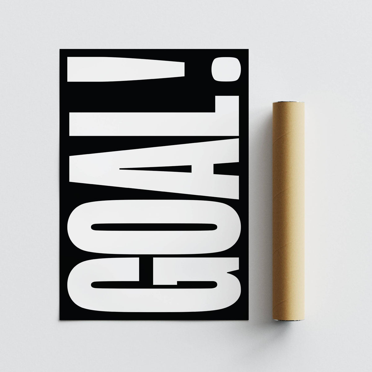 Goal Poster lying flat with bold white typography on a black background next to a brown packaging tube