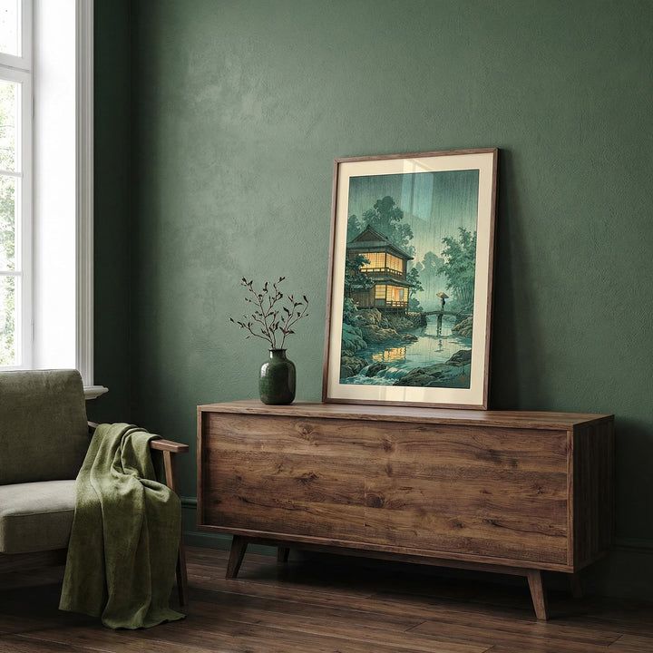 Japanese Landscape wall art leaning on wooden sideboard with green vase in a green-walled room