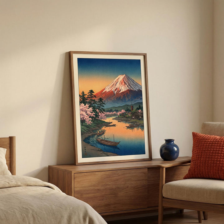 Mount Fuji Sunset Poster print leaning on a wooden sideboard with a blue vase in a beige room