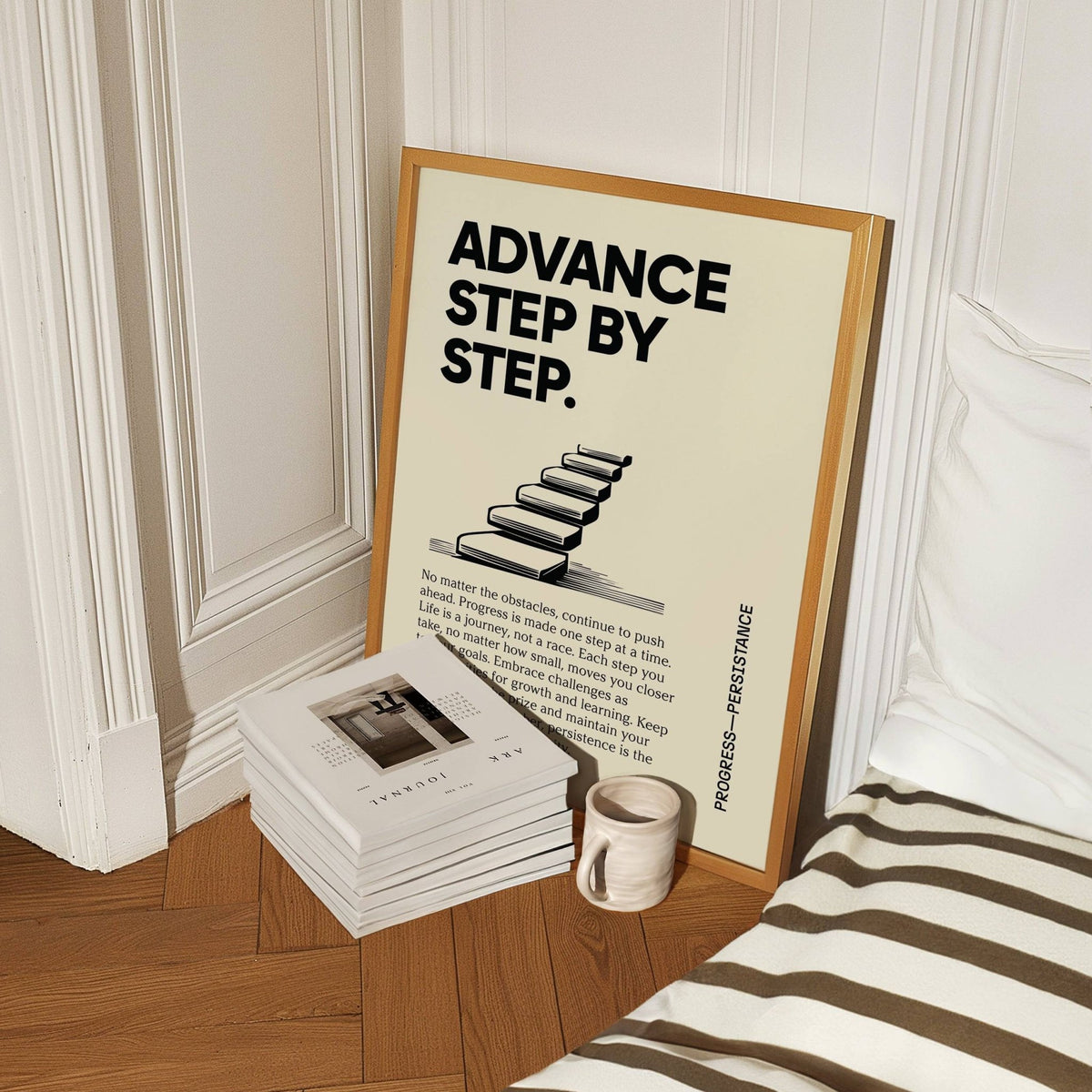 Poster of Motivation leaning on the floor beside a white ceramic mug and stack of books