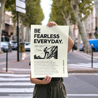 Person holding positive poster art with rock climber illustration outdoors on a street