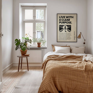 Motivational poster wall art with silhouette and sunrise in a bedroom with a plant on a stool
