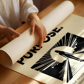 Detail close-up of motivational poster with silhouette and sunrise in black on cream paper held on a wooden table