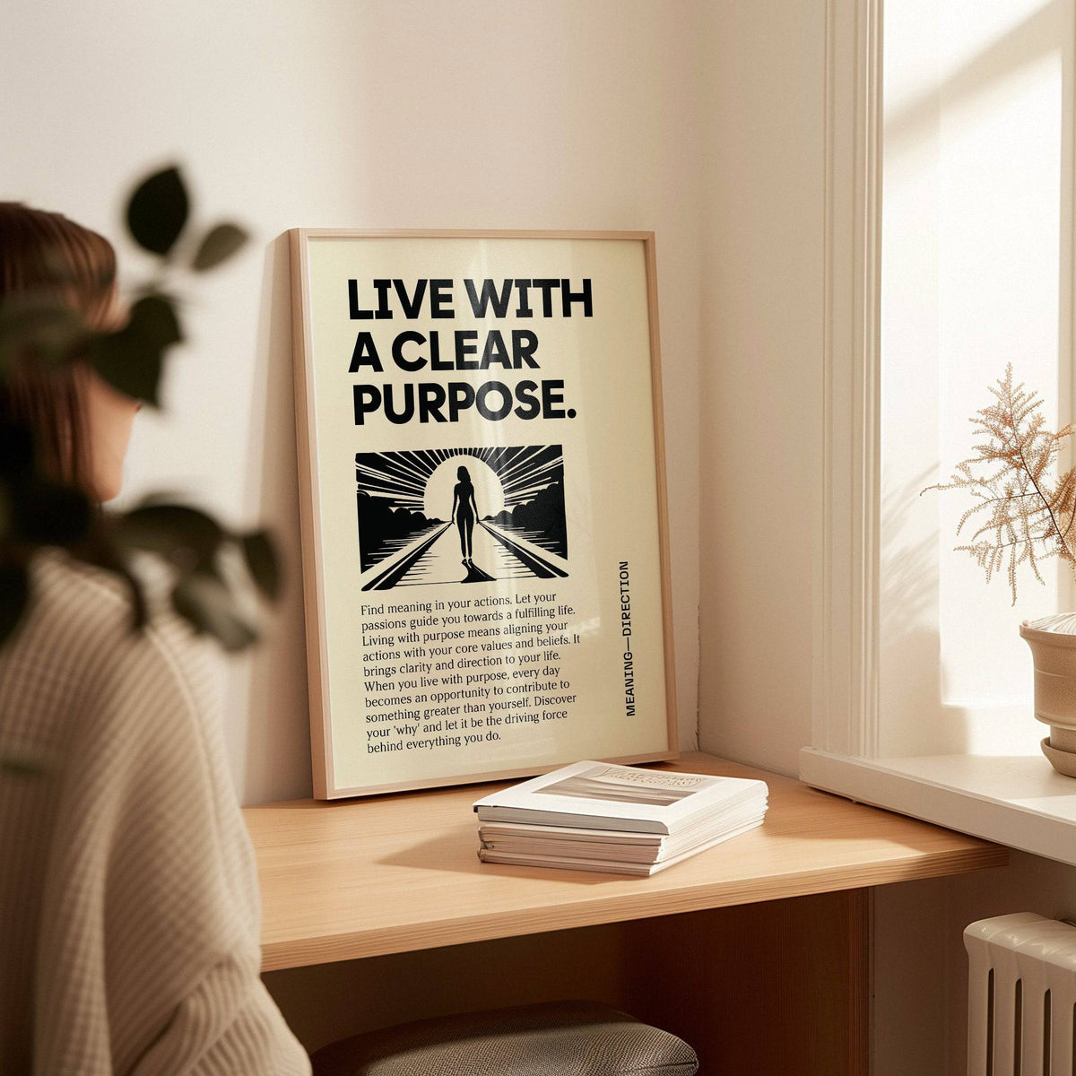 Motivational Poster leaning on a desk with a plant and books in soft natural light