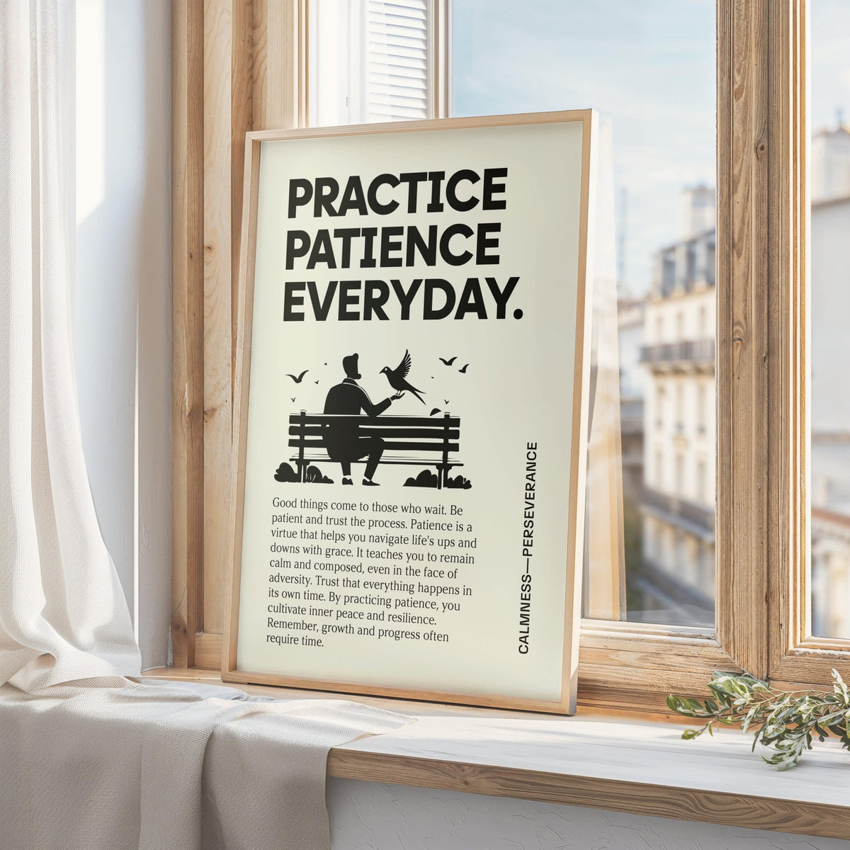 Framed Motivational Quotes Posters leaning on a window ledge with a plant and city view