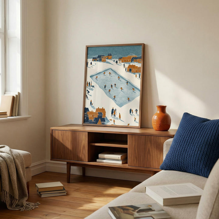 Print leaning on a shelf of Ice Skating Poster with minimalist people skating in muted blues and browns in a softly lit living room
