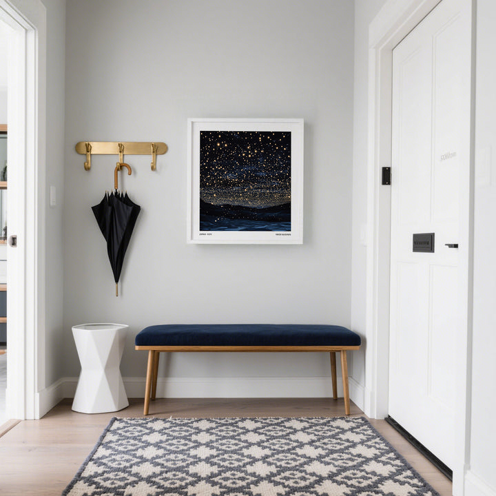 Starry Night Print on a grey hall wall above a blue cushioned bench with a gold umbrella stand