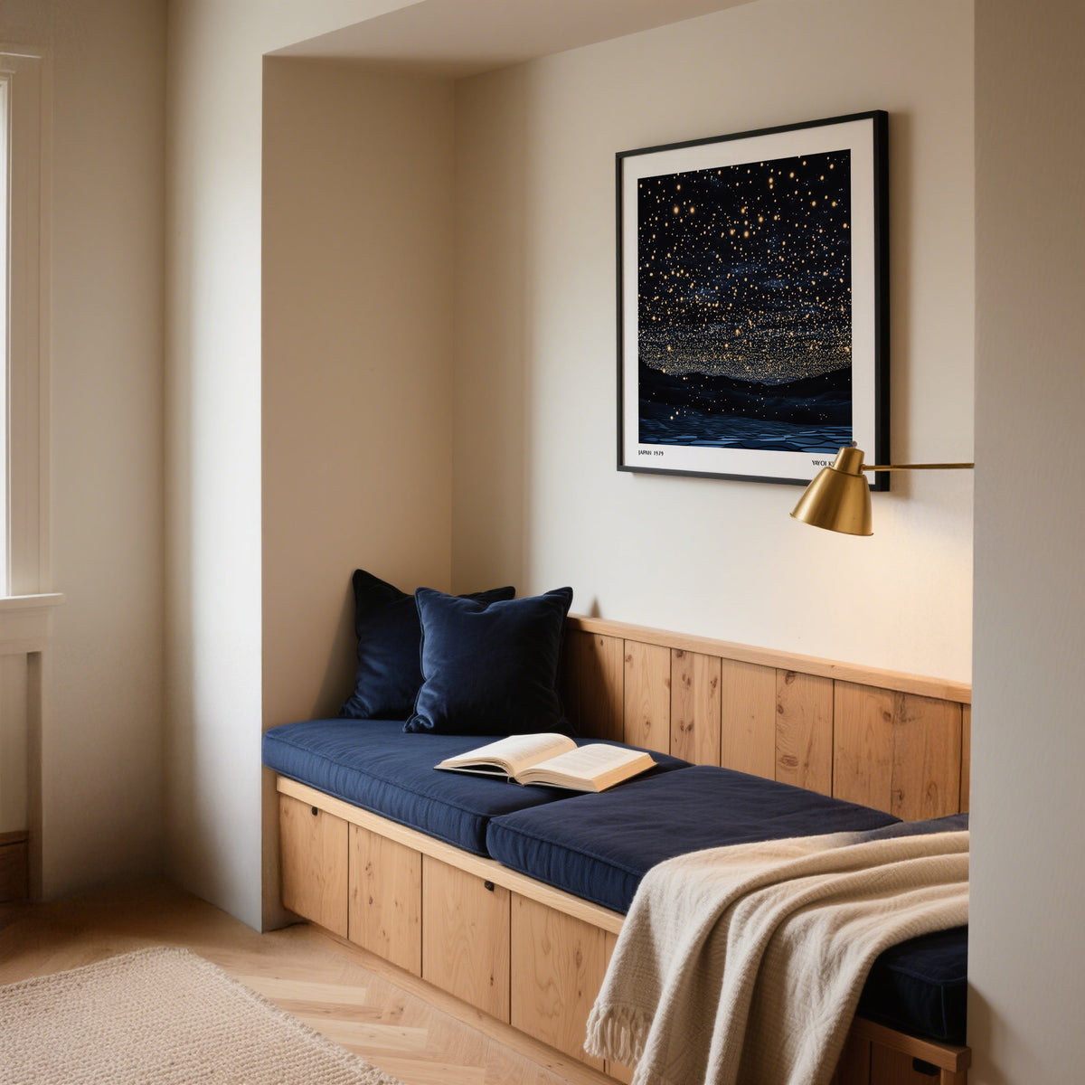 Starry Night Print leaning on a wall with dark blue cushions and a brass wall lamp