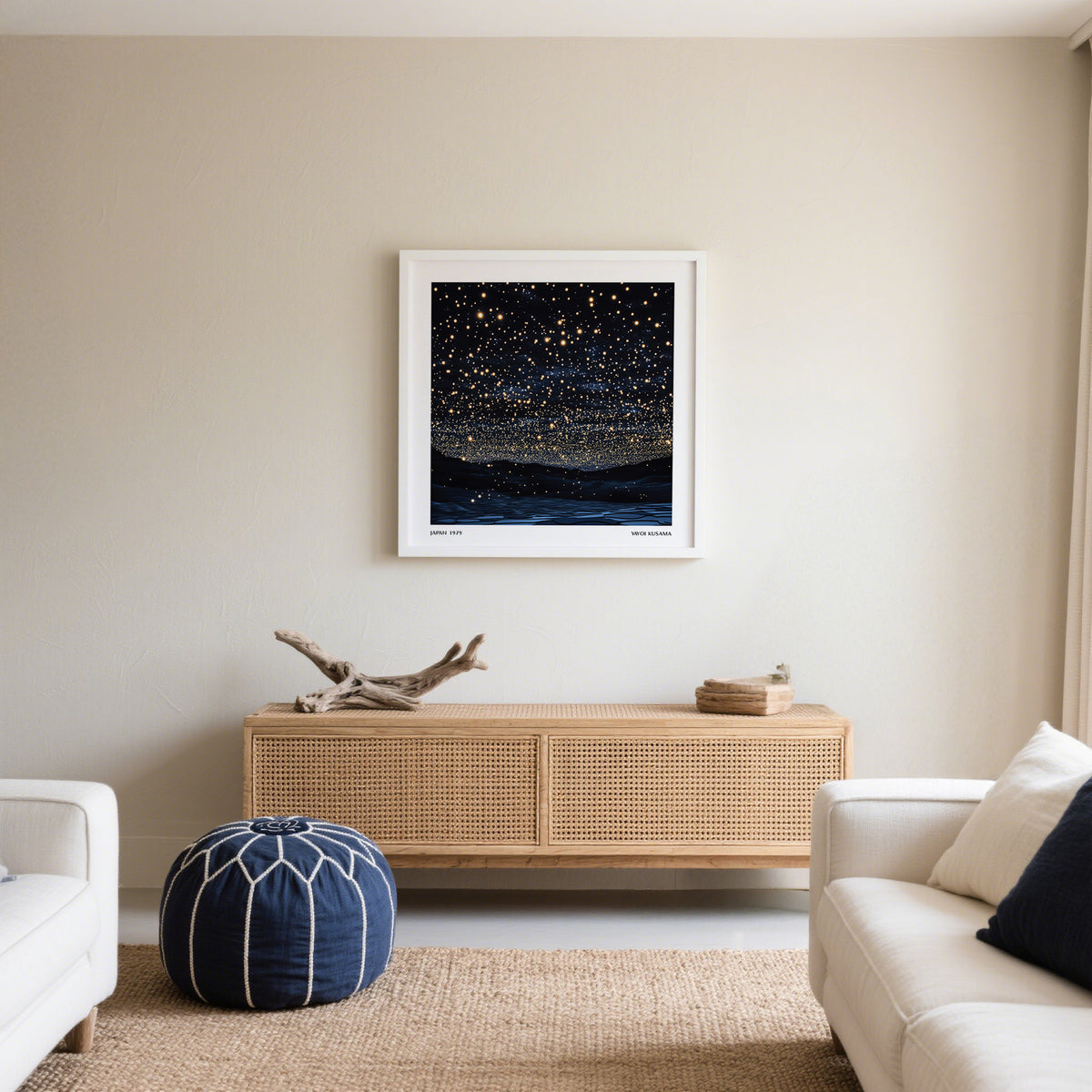 Starry Night Print hanging above a wooden sideboard with a decorative branch and folded cloth