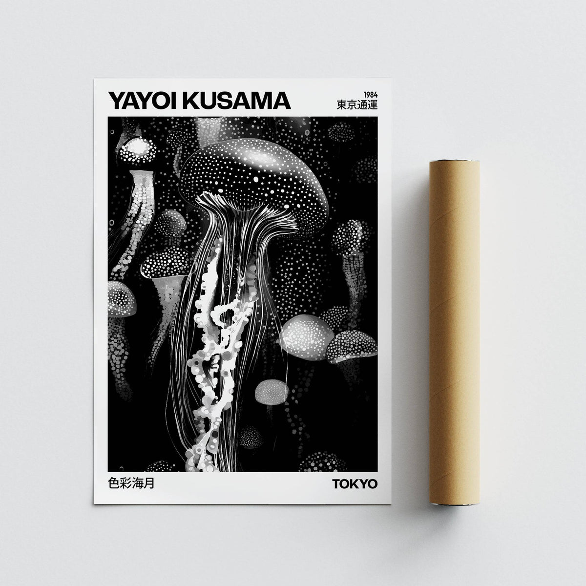 Jellyfish art print in monochrome laid flat alongside a brown packaging tube