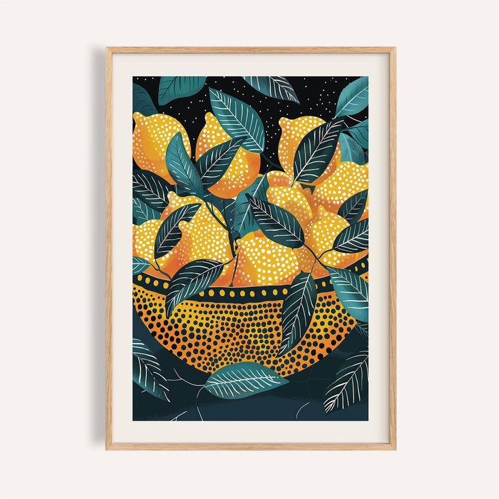Framed print of lemon wall art showing yellow lemons in a patterned bowl with green leaves on a dark background