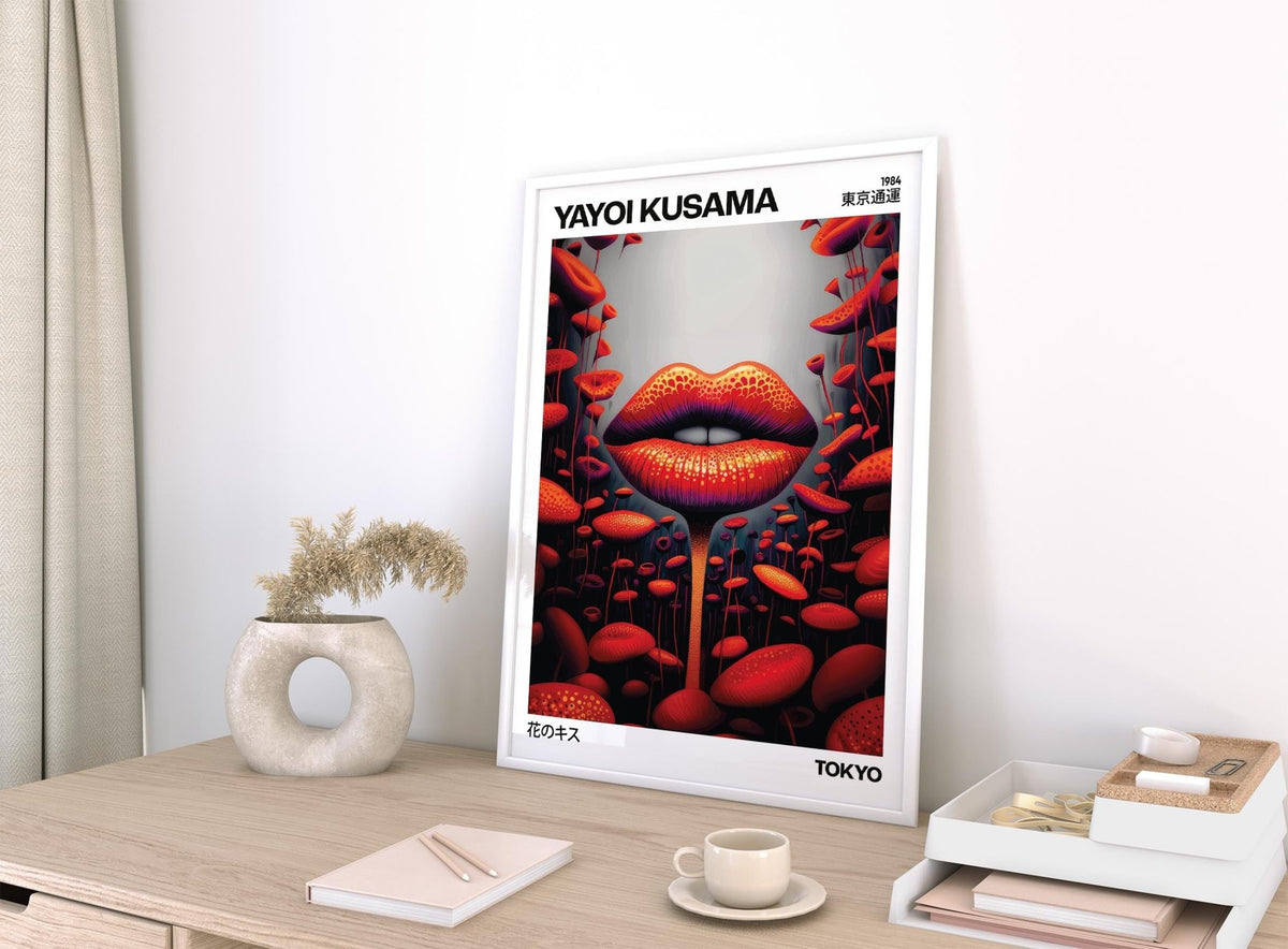 Print leaning on a desk of lips mushroom artwork in red orange tones with a soft sculpture nearby