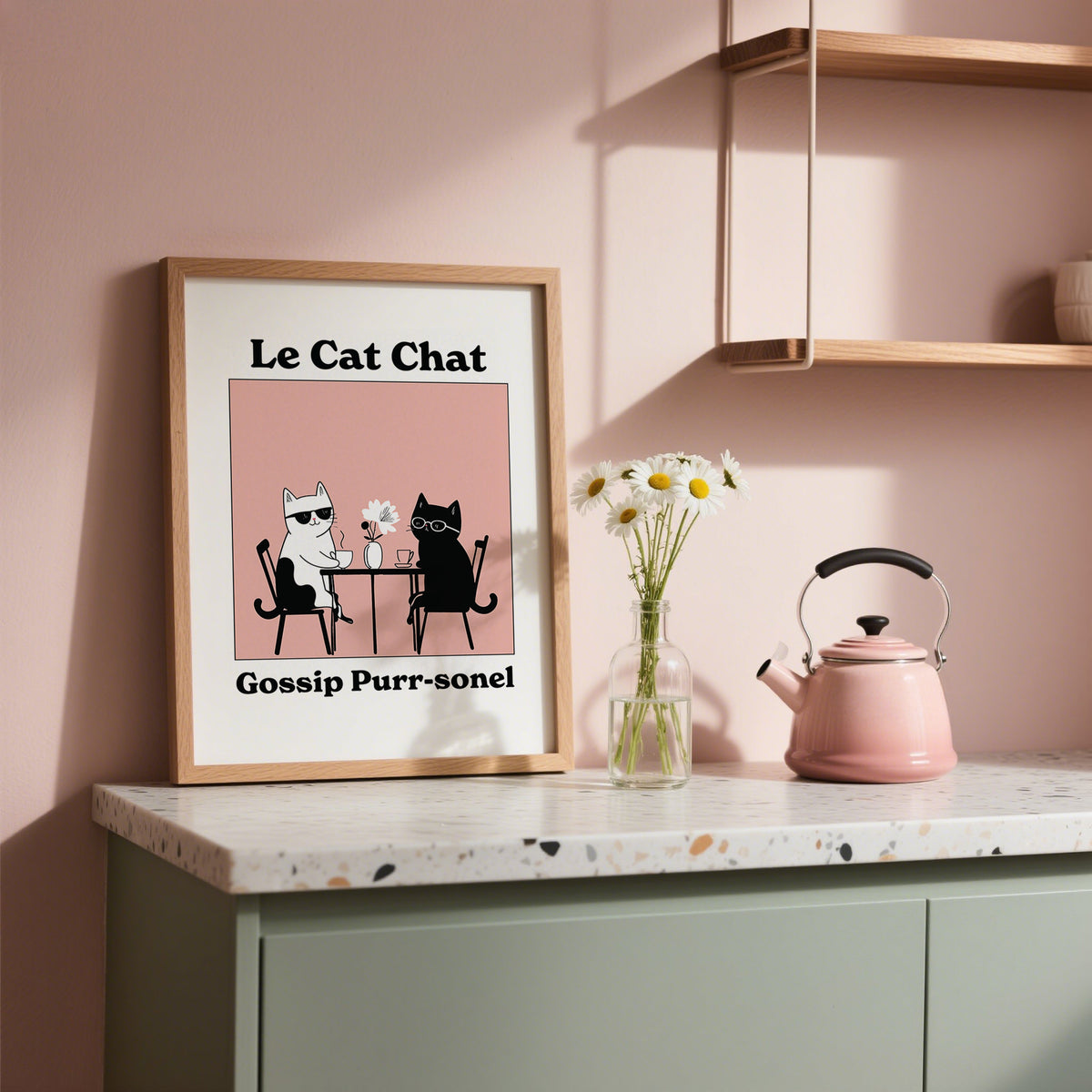 Framed Funny Cat Artwork of two cats at a table with pink background on a kitchen counter