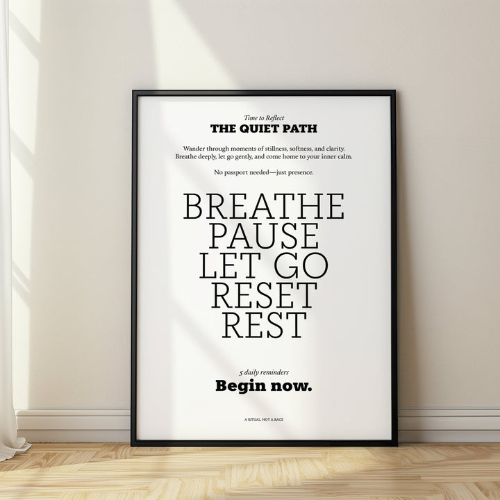 Meditation poster with a black frame and an inspirational quote leaning on light wooden flooring near a white wall