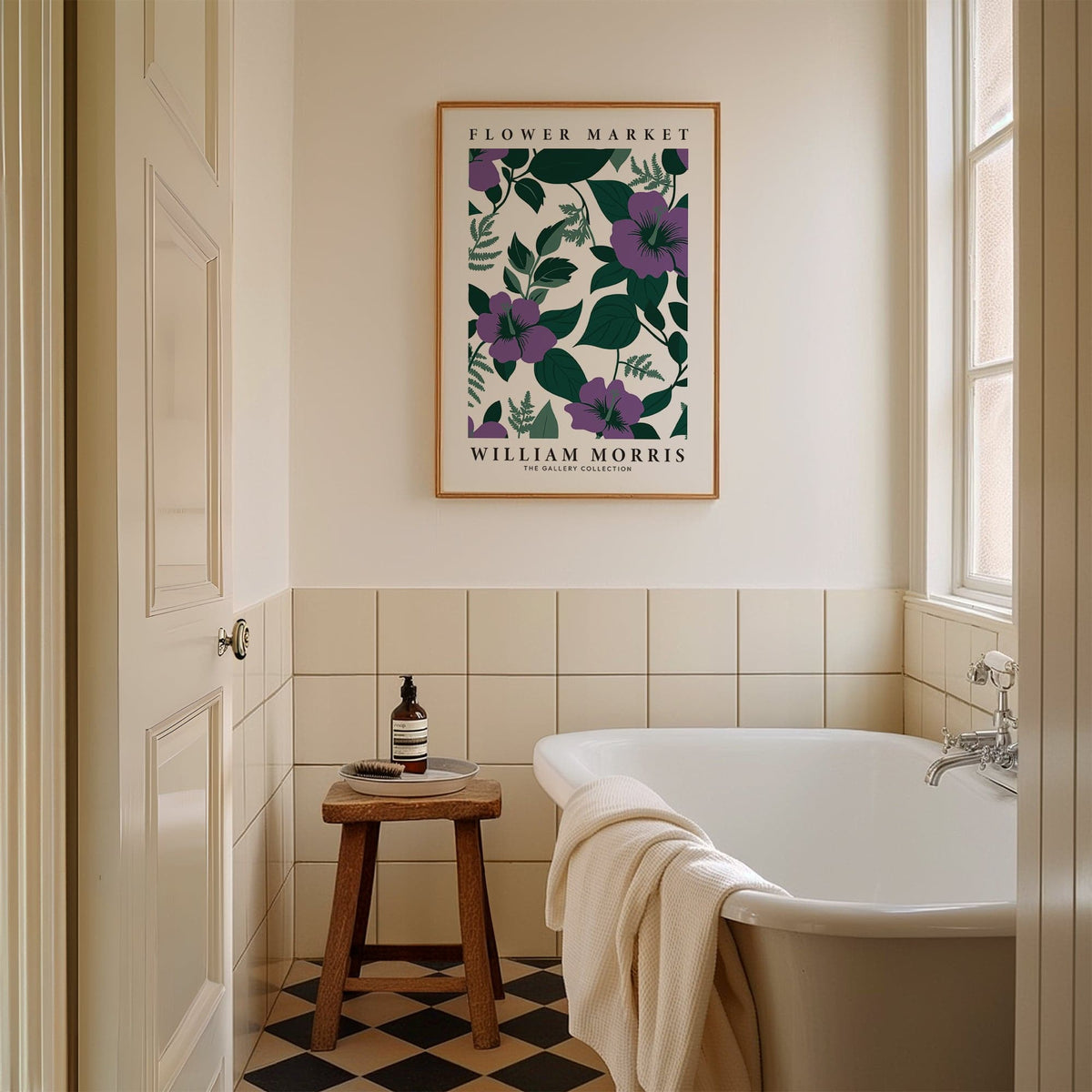 Purple flower artwork framed and hung above a stool in a bathroom with a bathtub and tiled walls