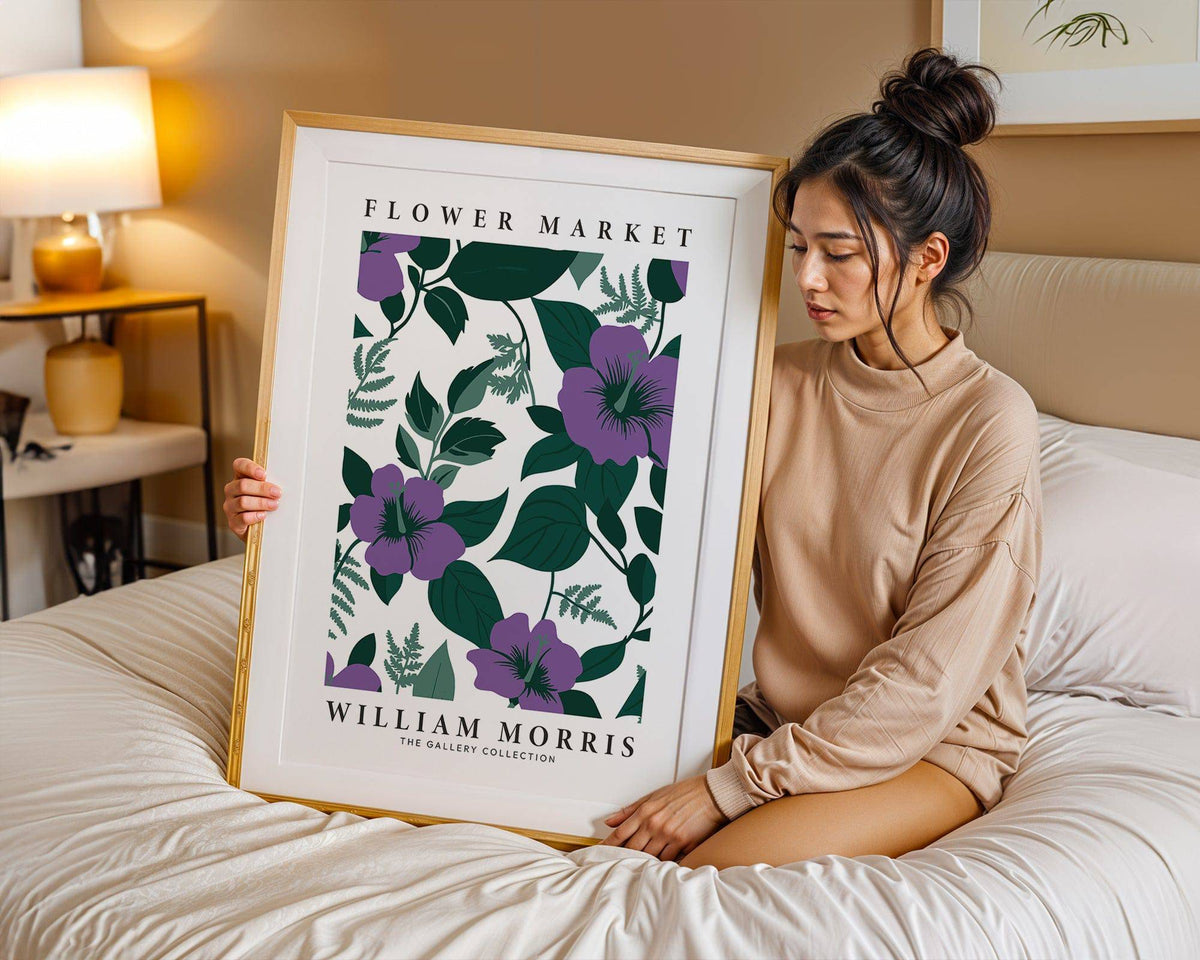 Framed Purple Flower Artwork with purple flowers and green leaves held by woman on bed