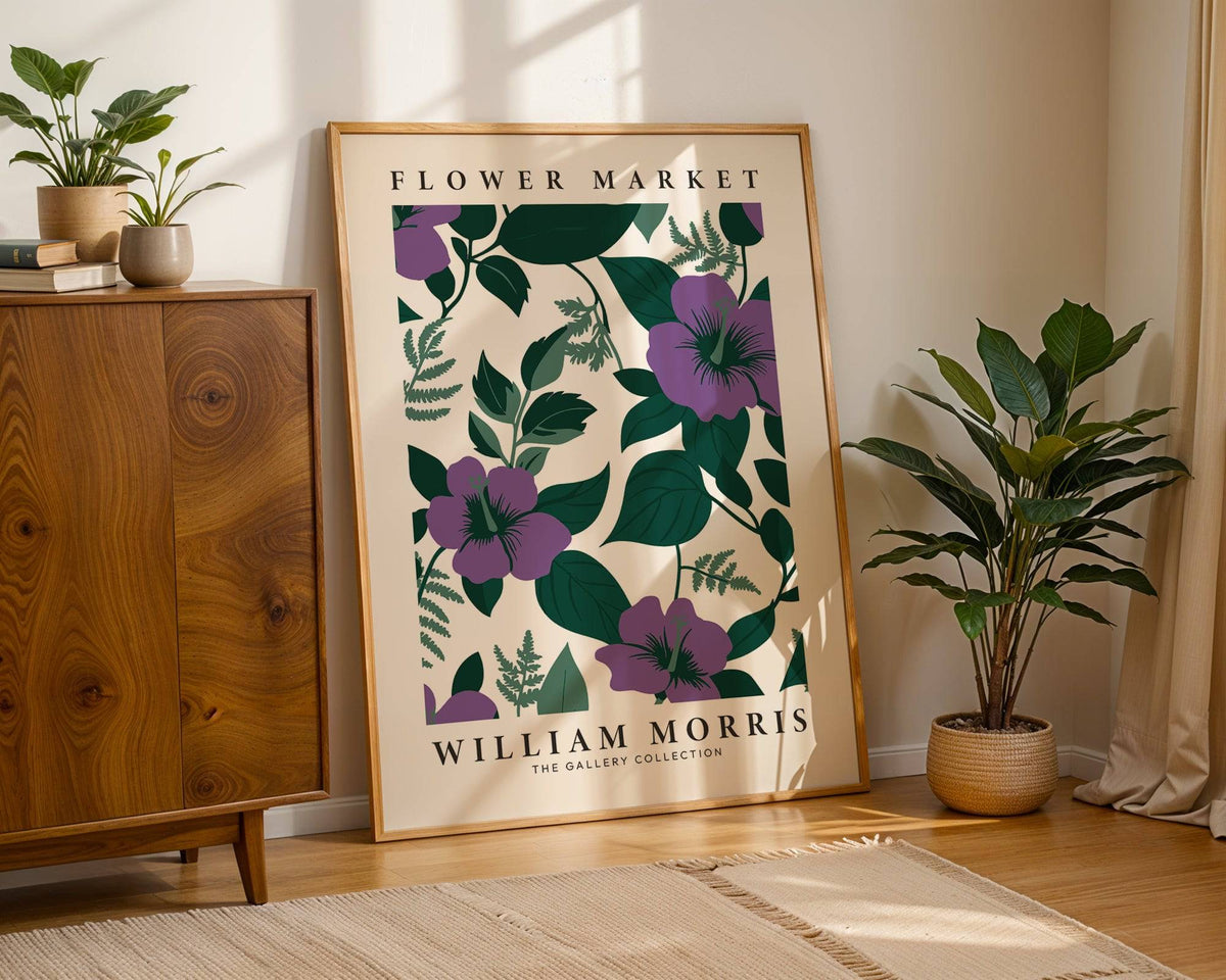 Purple Flower Artwork print leaning on a wooden floor with a green potted plant nearby
