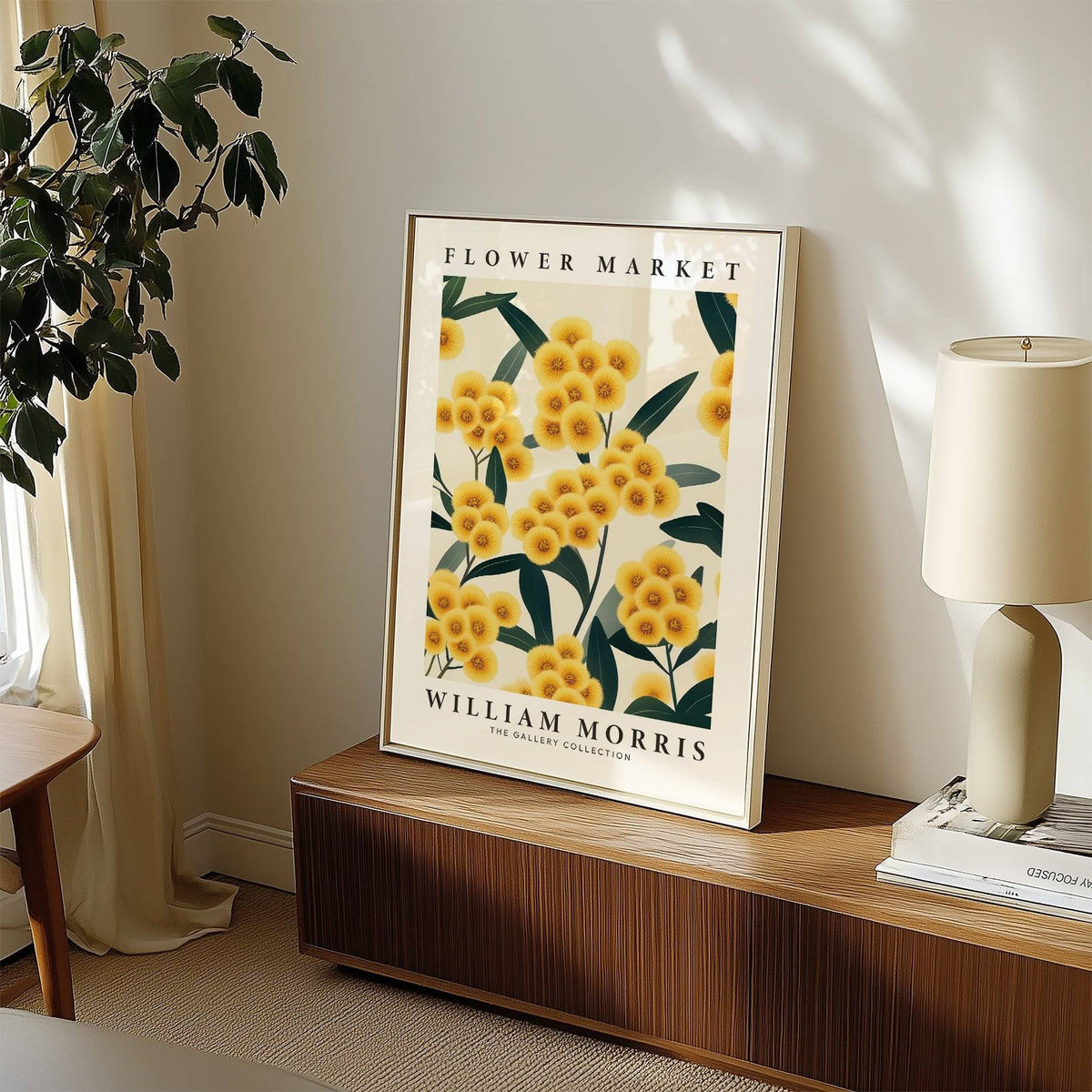 Print leaning on a shelf of yellow pompom flowers with green leaves near a table lamp