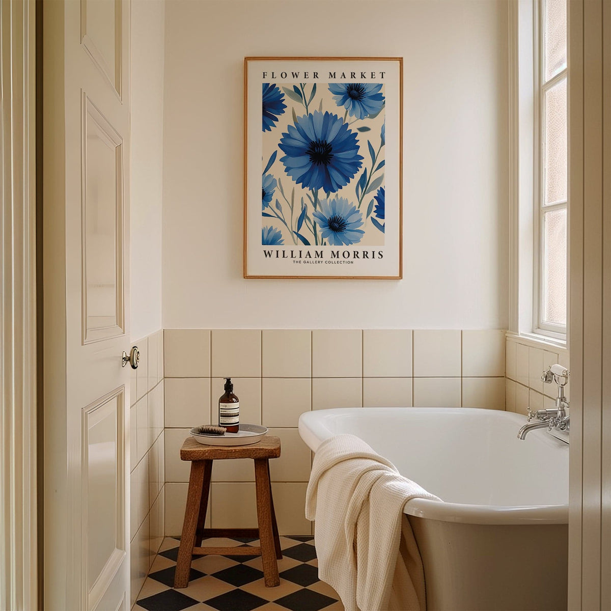 Botanical print of blue flowers in minimalist style above a wooden stool in a bathroom