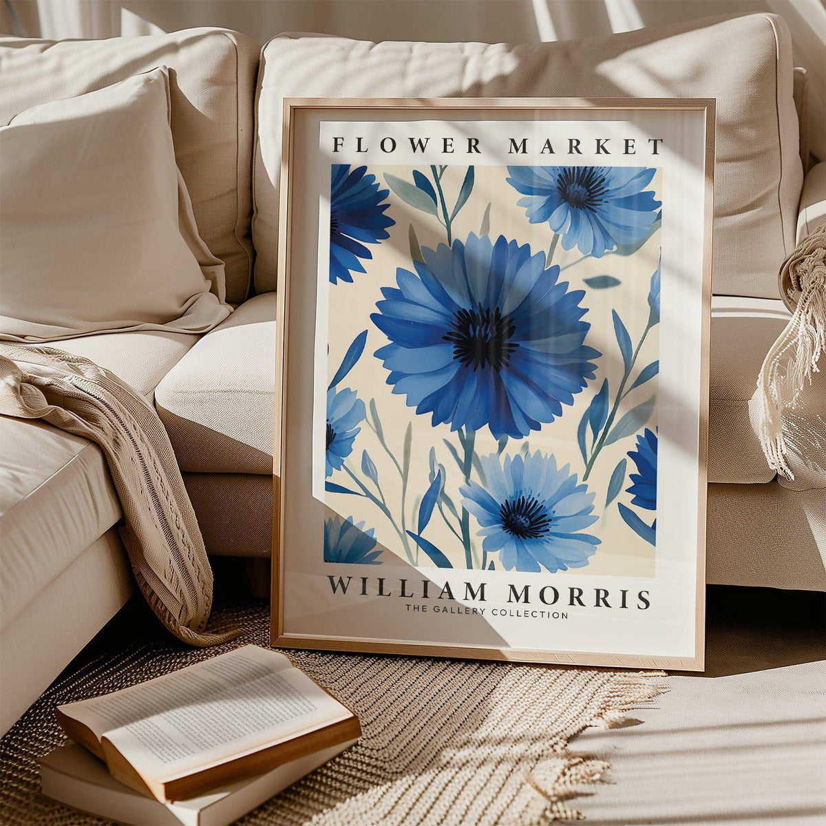 Print leaning on a beige sofa of blue flowers with text and soft shadow