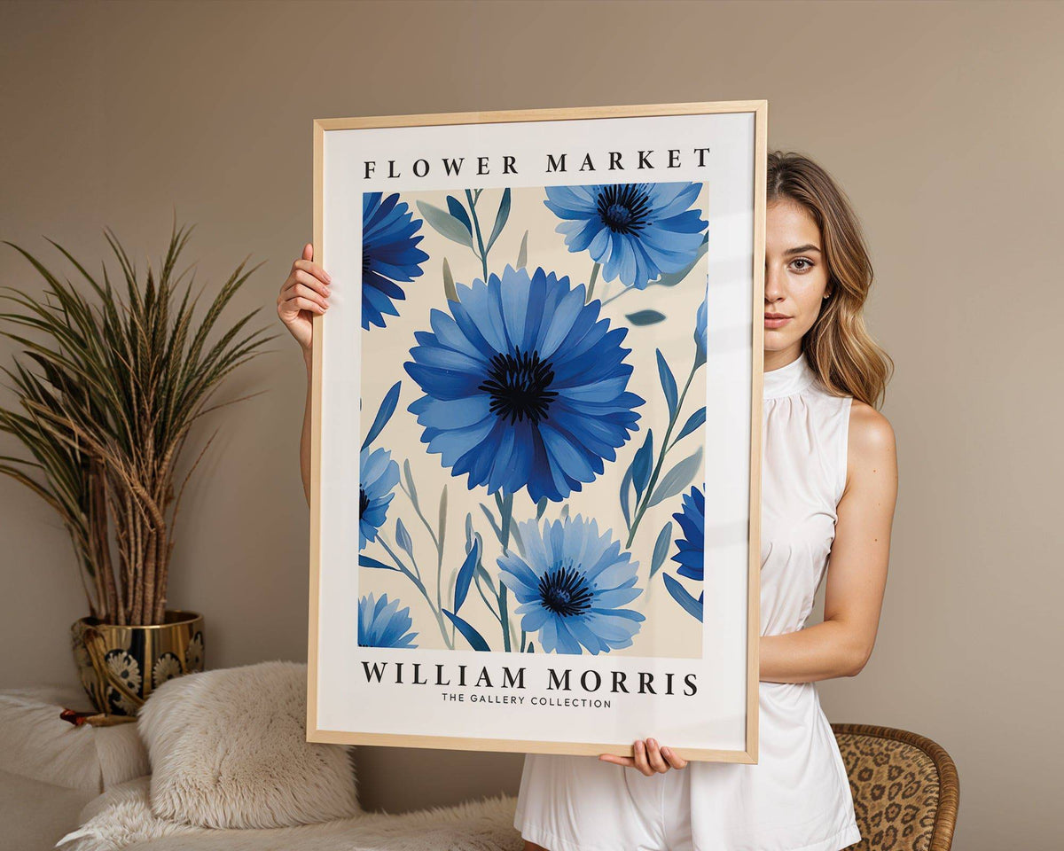 Framed Botanical Print of blue flowers held by a woman with a plant in the background