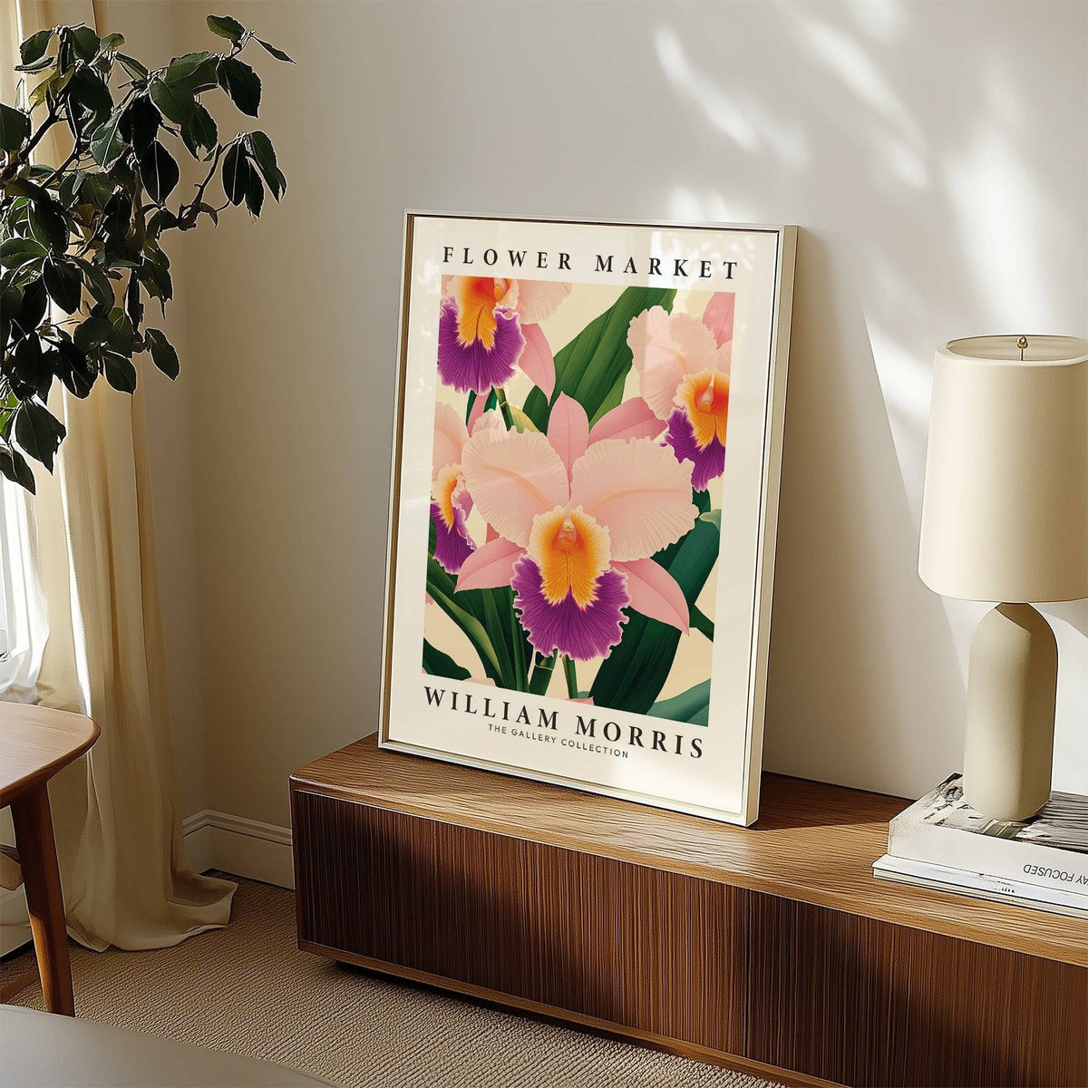 Wall Art Orchids print leaning on a wooden sideboard with a white lamp and books nearby