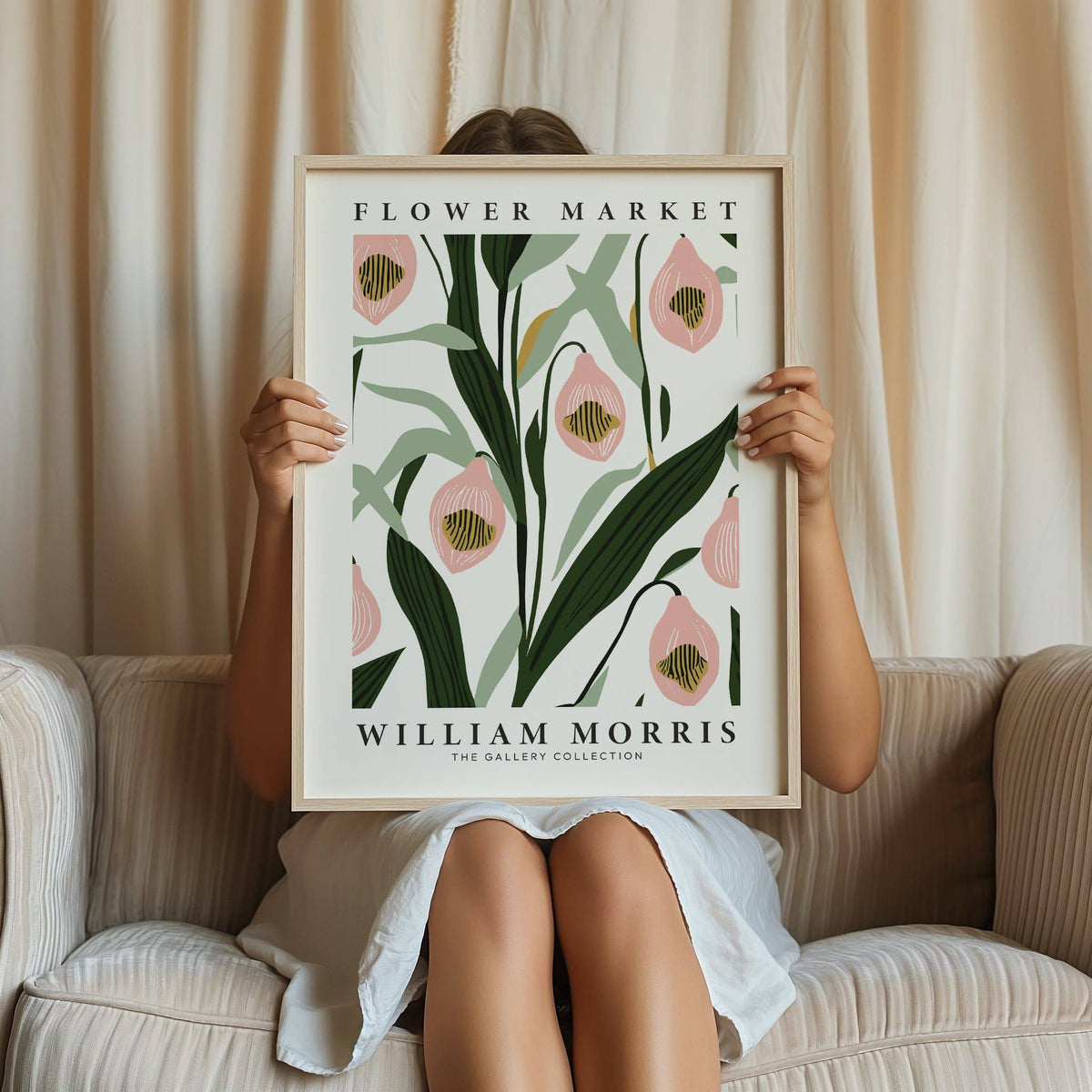 Paintings of Orchids framed print held by a person sitting on a beige striped sofa with cream curtains