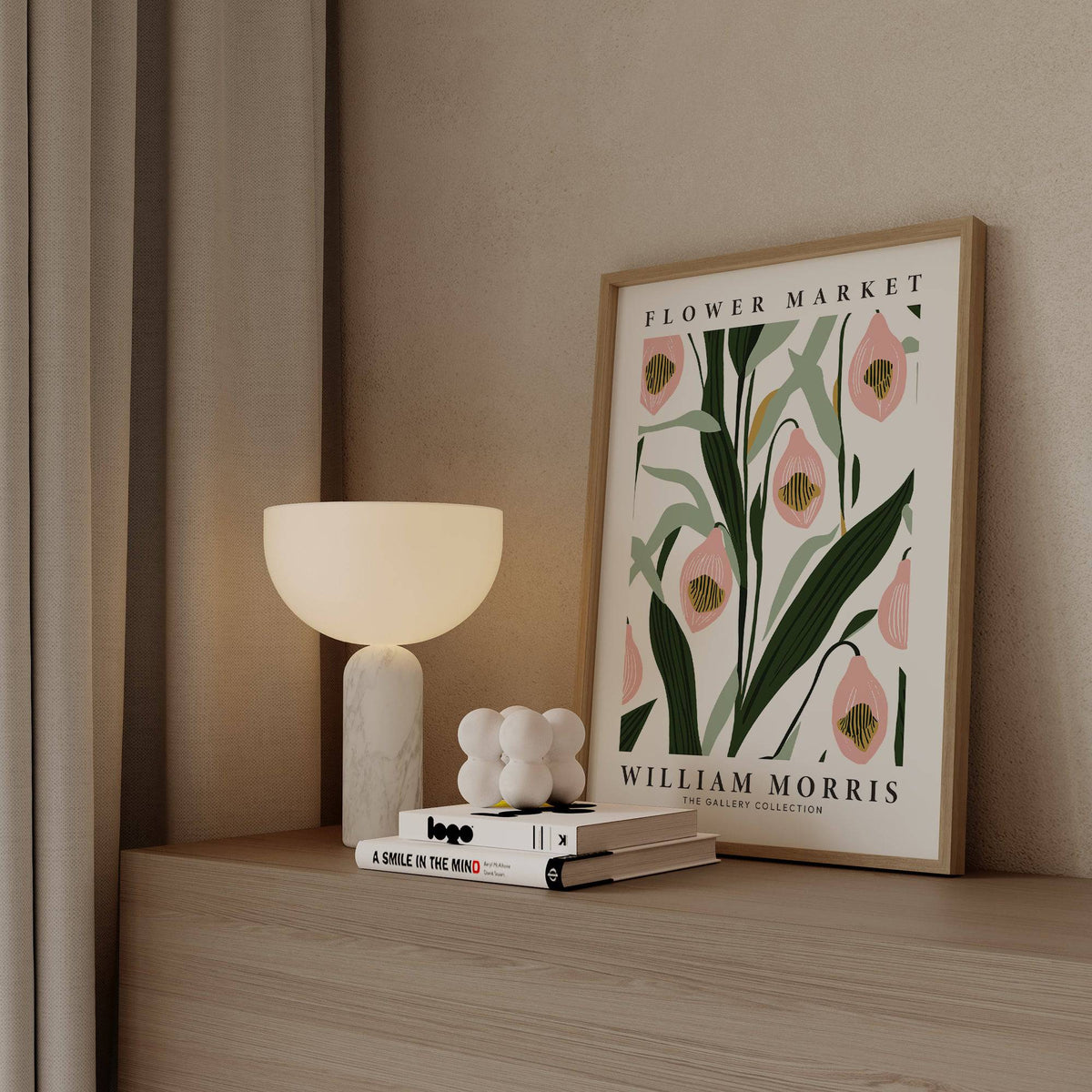 Paintings of Orchids print with pink orchids and green leaves leaning on a wooden surface beside a white lamp