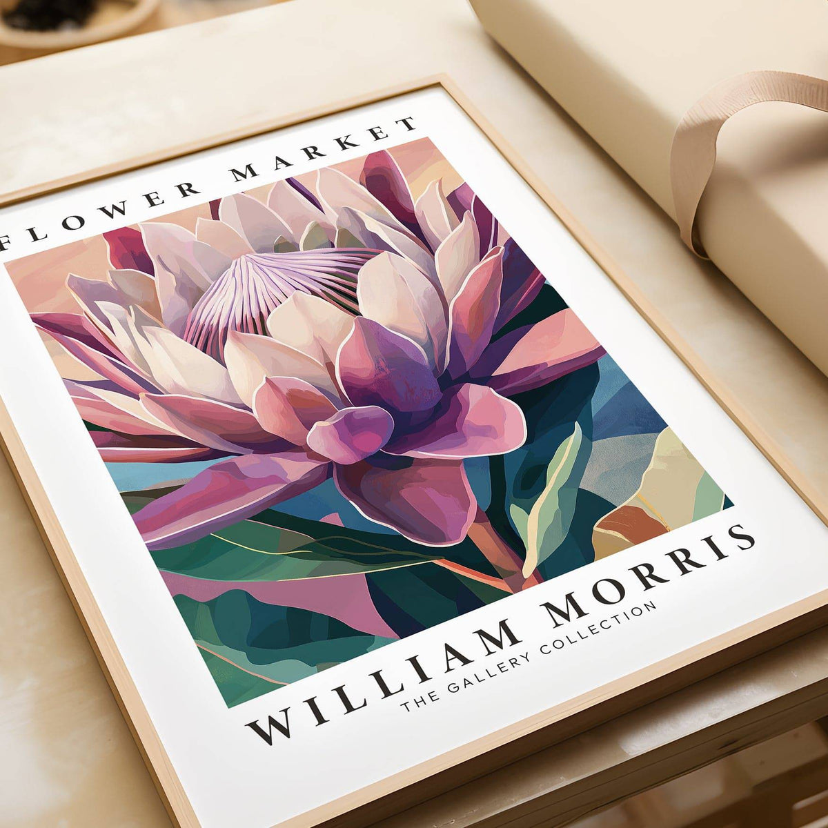Close-up of flower wall art showing a king protea flower illustration in soft pink green and blue tones on a table
