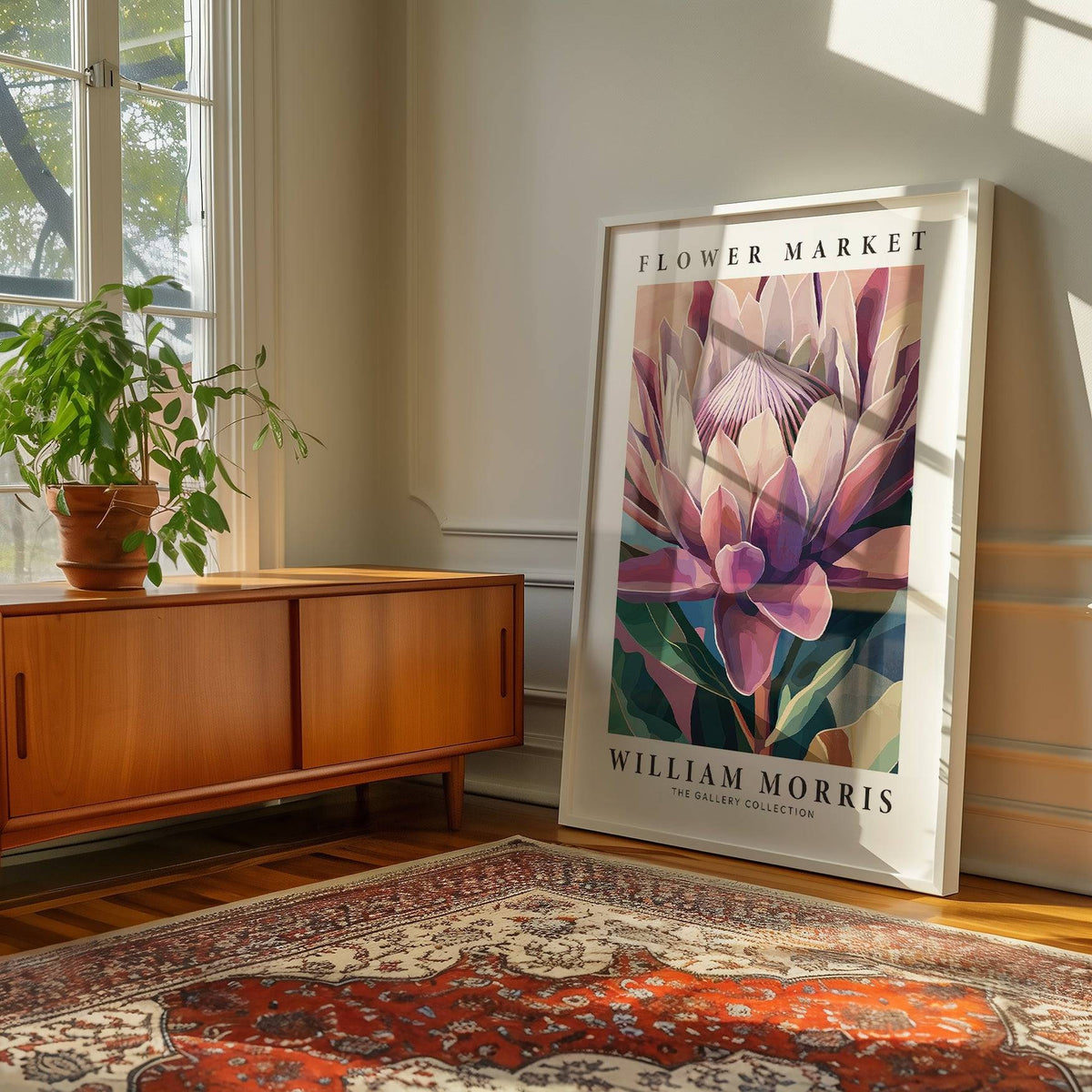 Flower wall art leaning on floor with king protea flower illustration near a wooden cabinet and plant