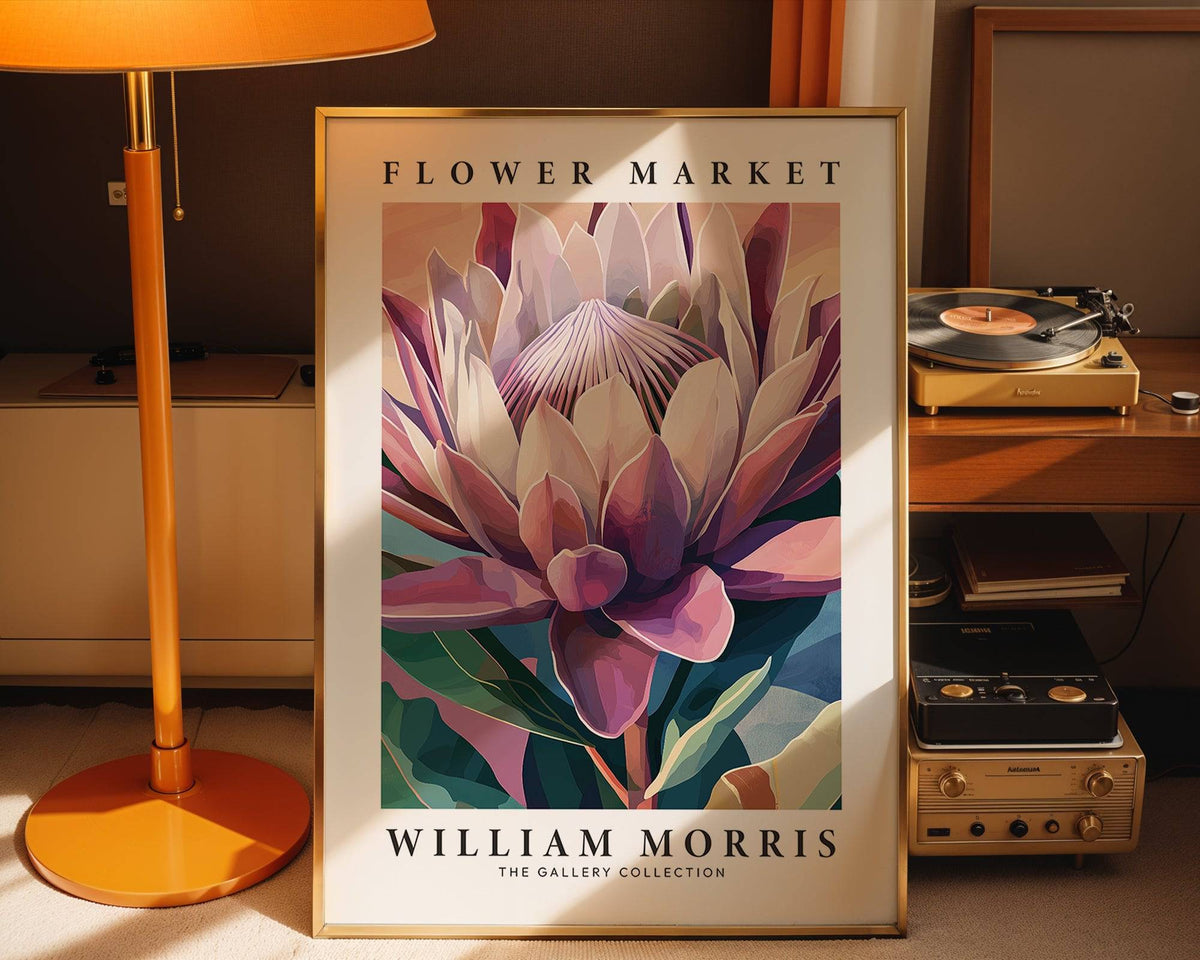 Flower wall art of a king protea flower in muted pinks and greens leaning by an orange lamp and vintage stereo
