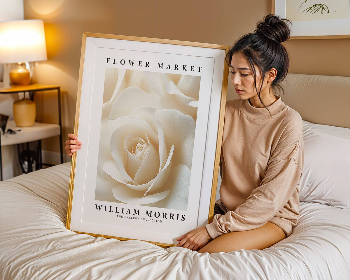Floral wall art for living room with a cream rose close-up held by a woman on a bed
