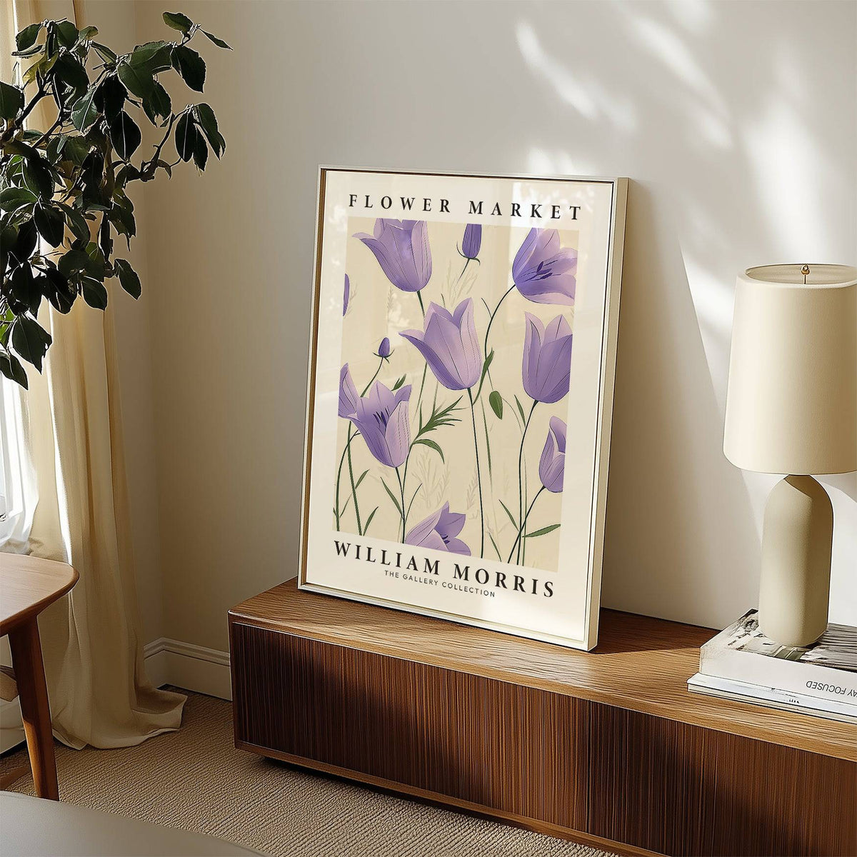 Wall Art Tulips print featuring purple bell flowers leaning on a sideboard with a lamp and books