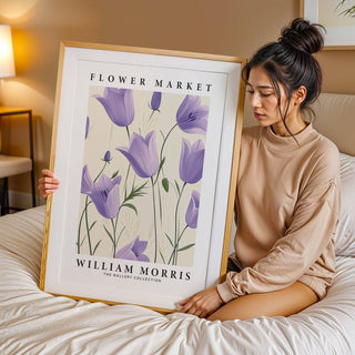 Wall Art Tulips framed print with purple bell flowers held by a woman on a bed