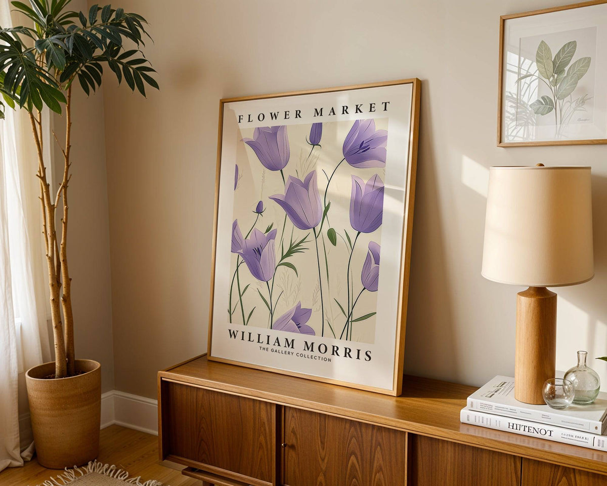 Print leaning on a shelf with purple bell flowers in an illustration style next to a lamp