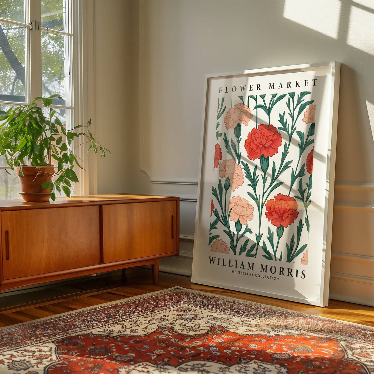 Print leaning on floor of carnation flowers in green and pink tones beside wooden cabinet and plant in living room