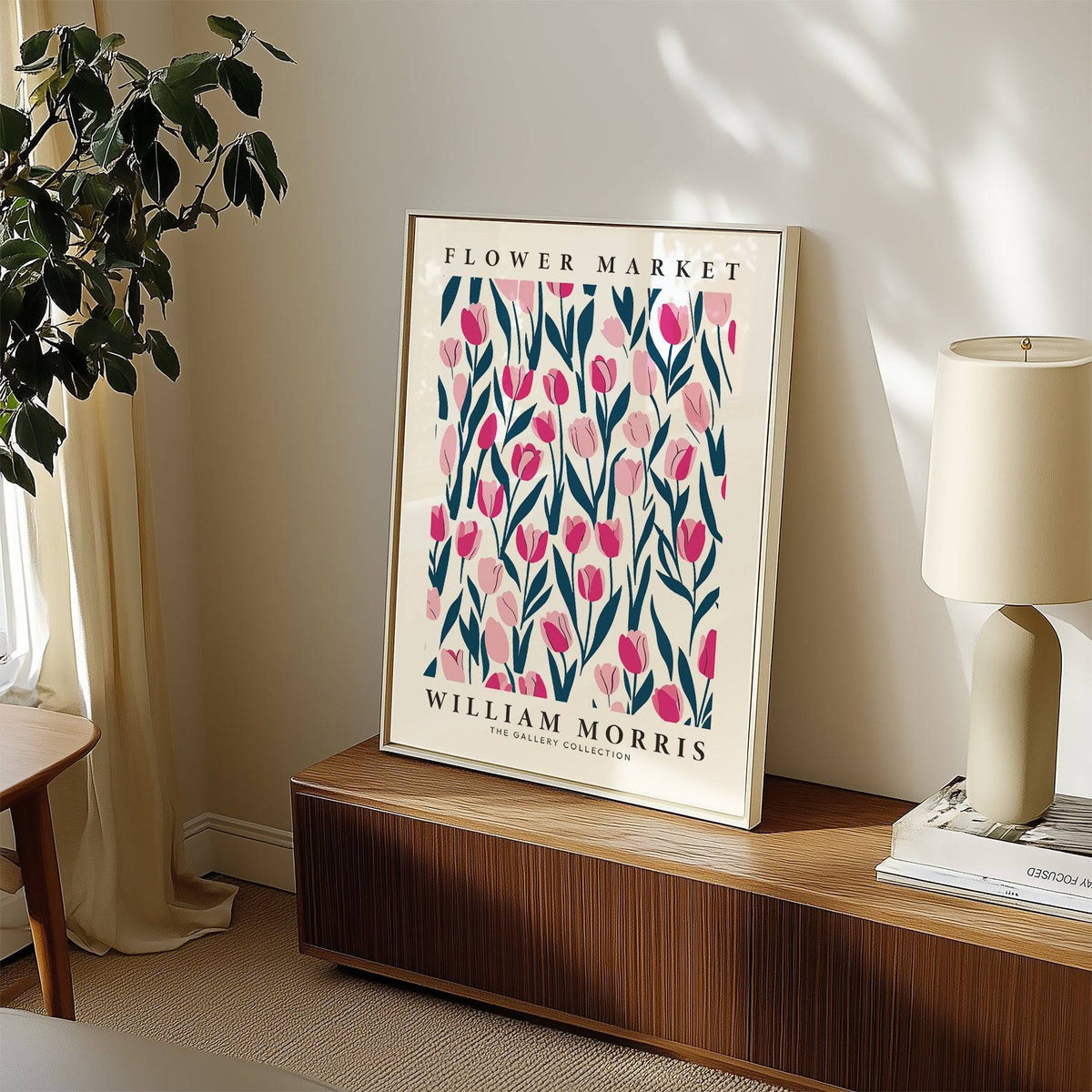 Tulip decor print leaning on a wooden sideboard with pink tulips in blue and pink tones and a cream lamp nearby